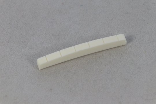 Fender style bleached bone nut, shaped and slotted, 7.25" top and bottom radius